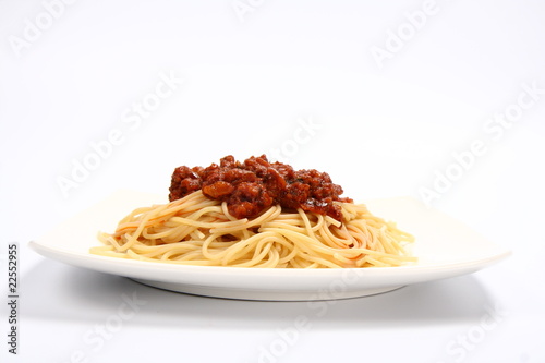 Pasta bolognese on a plate on white background
