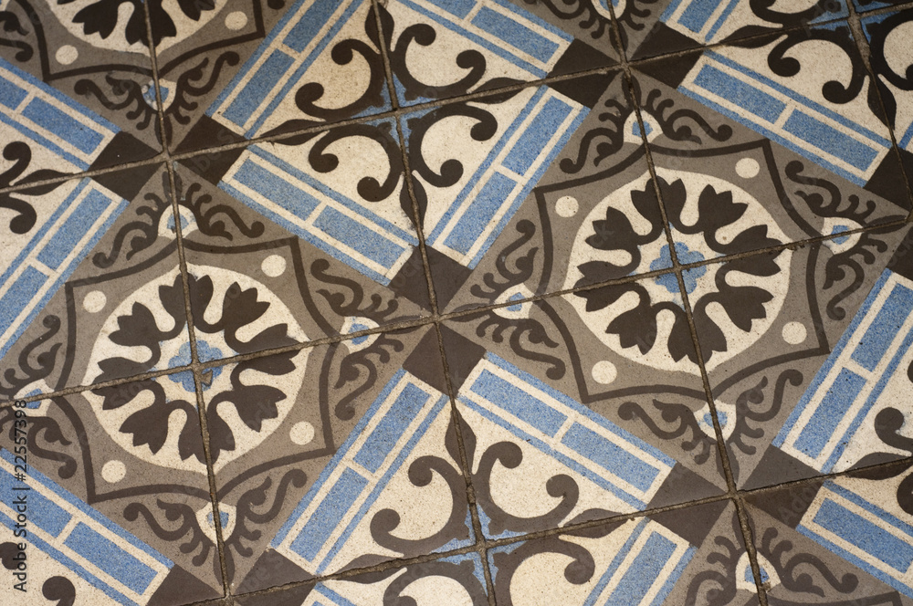 Old floor tile pattern in brown and blue