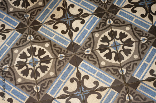 Old floor tile pattern in brown and blue © annavee