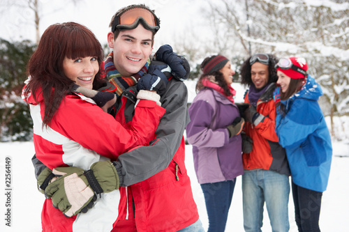 Group Of Teenage Friends Having Fun In Snowy Landscape Wearing S