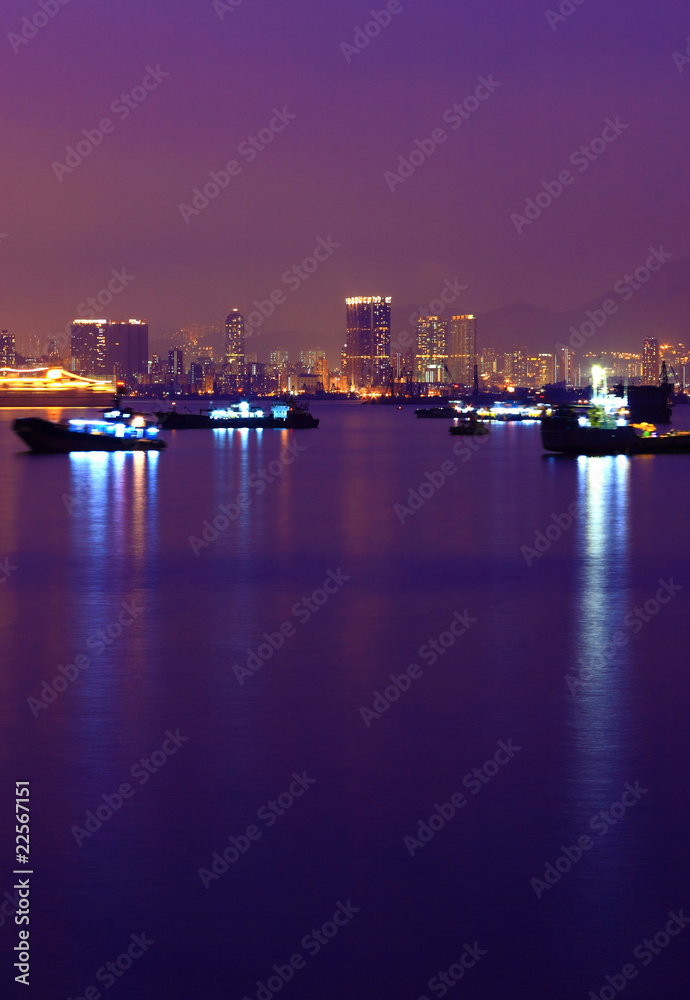 Ship in harbour at night with reflection