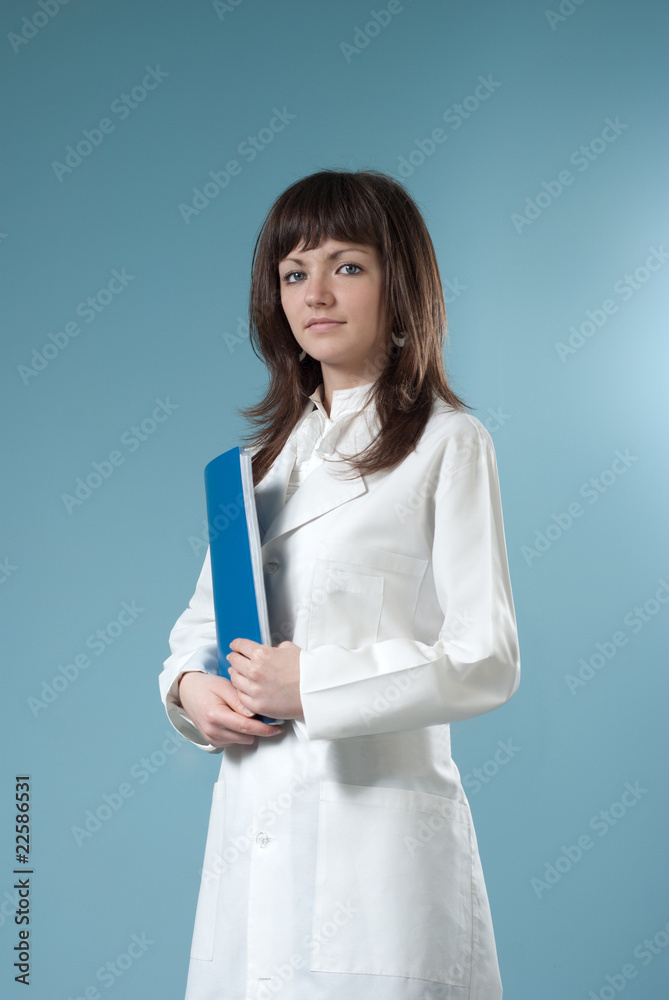 Healthcare collection - Pretty brunette doctor with blue folder
