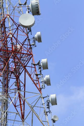 Close-up of a telecommunications tower against blue sky