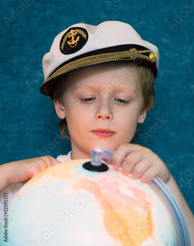 Portrait of the dreaming child with the globe model photo