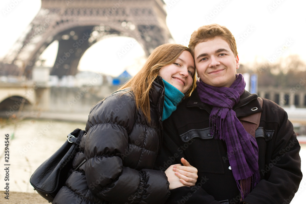 Happy couple in love in Paris near the Eiffel Tower