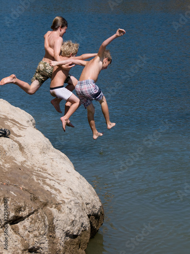 Excited Boys Jumping into Lake