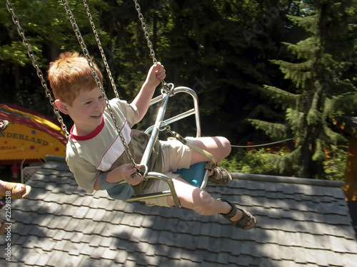 young boy enjoys the carrousell photo