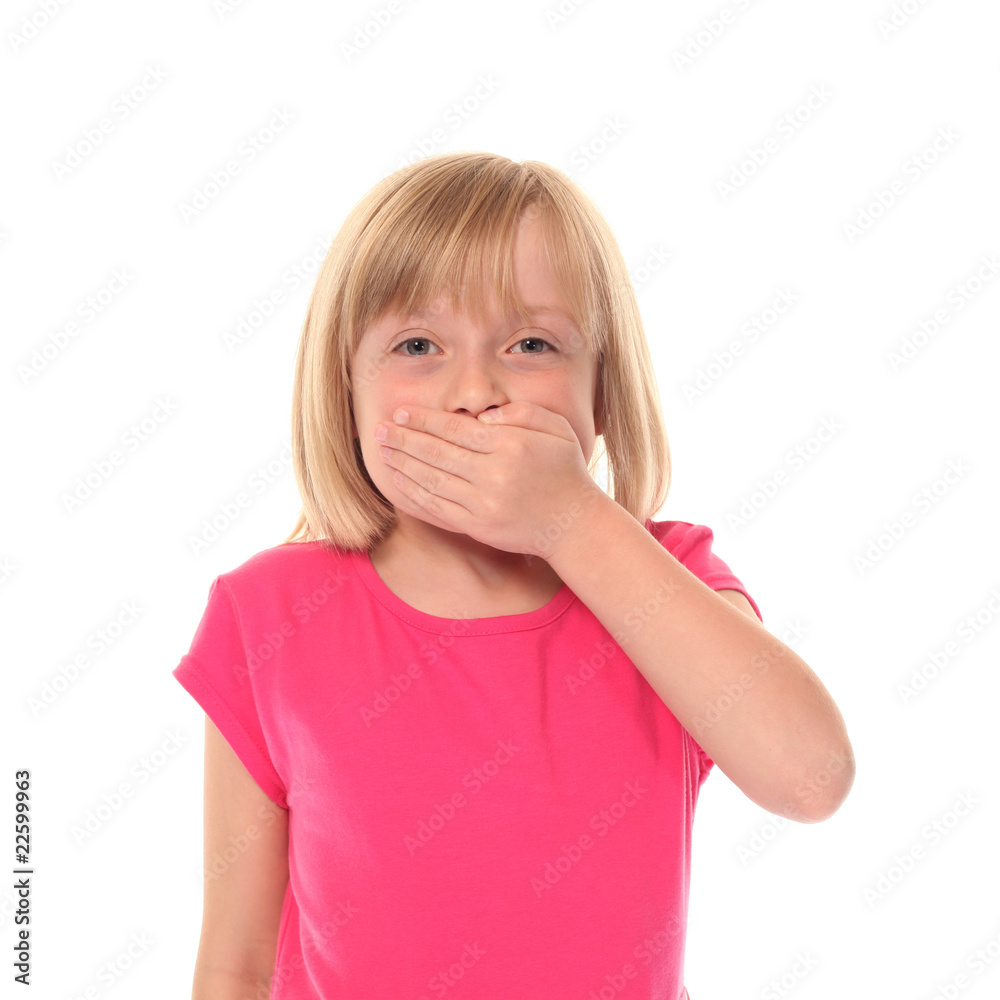 Young little girl covering mouth