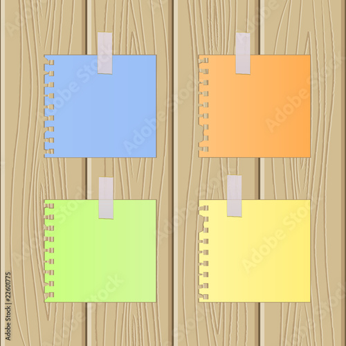 The multi-coloured sheets of paper pasted on a wooden surface