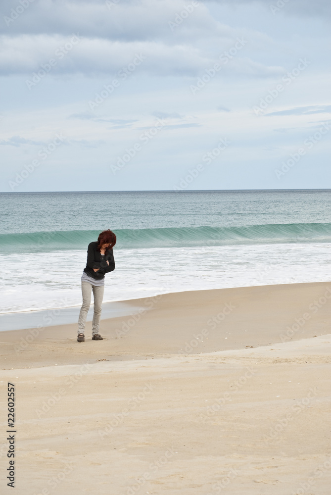 Thoughtful woman at the beach