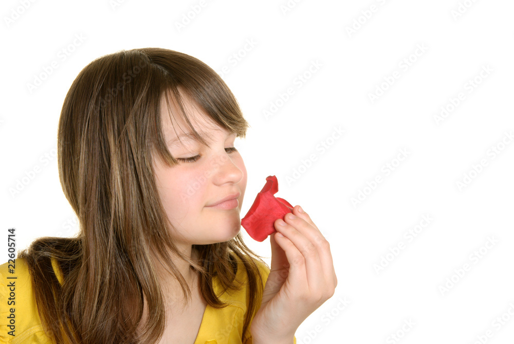 Girl holds petal of flower and smells Girl holds petal of flower and smells