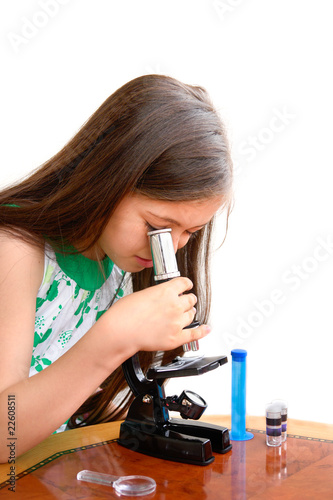 Girl looks through microscope
