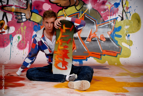 Boy skateboard, graffiti wall