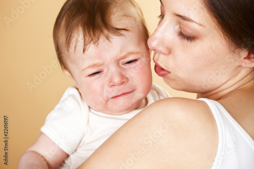 baby boy crying in mothers arm