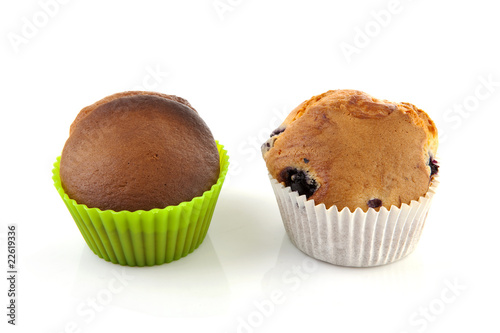 Two home baked muffins over white background