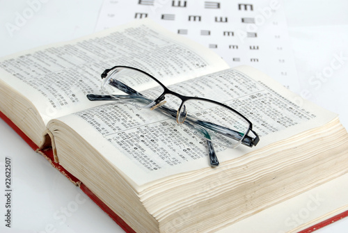 glasses, dicitonary and eye chart
