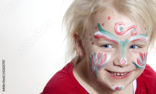 Fototapeta Naklejka Na Ścianę i Meble -  Smiling little girl with colored painted face
