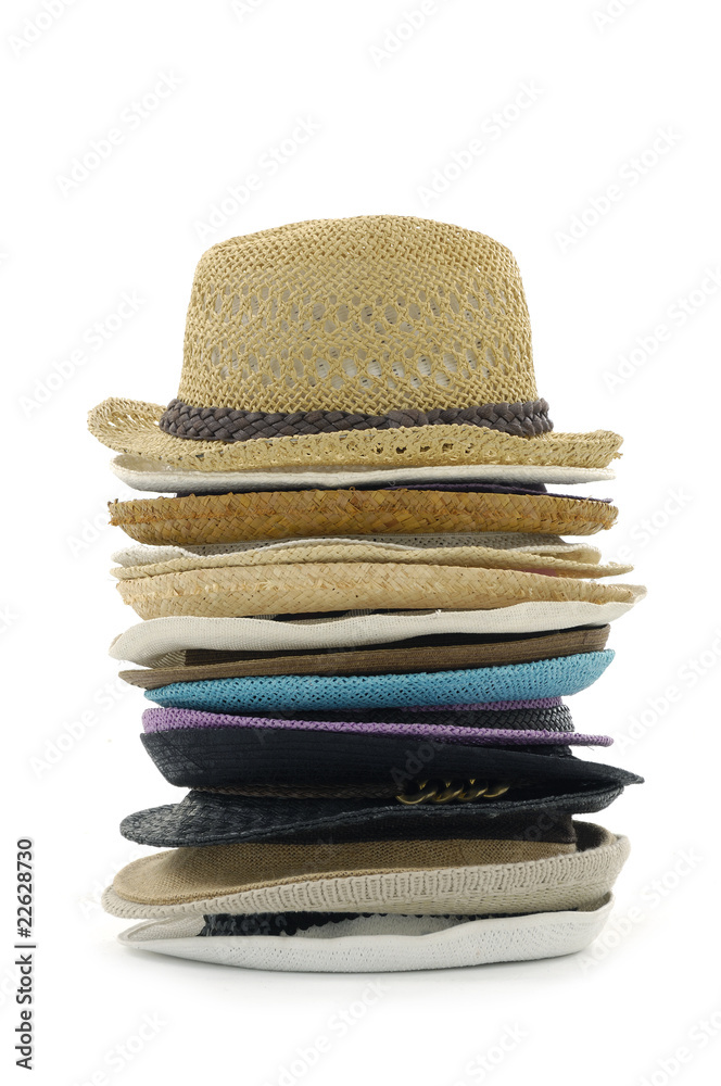 Stacks of straw hats on white