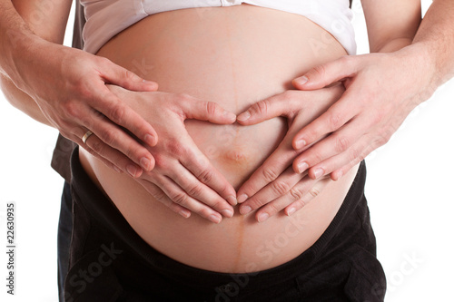 Advanced pregnant belly with hands © mathom