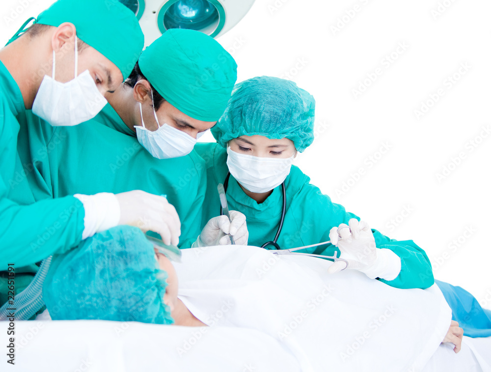 Medicalteam making an operation using surgery equipment on a pat Medicalteam making an operation using surgery equipment on a pat