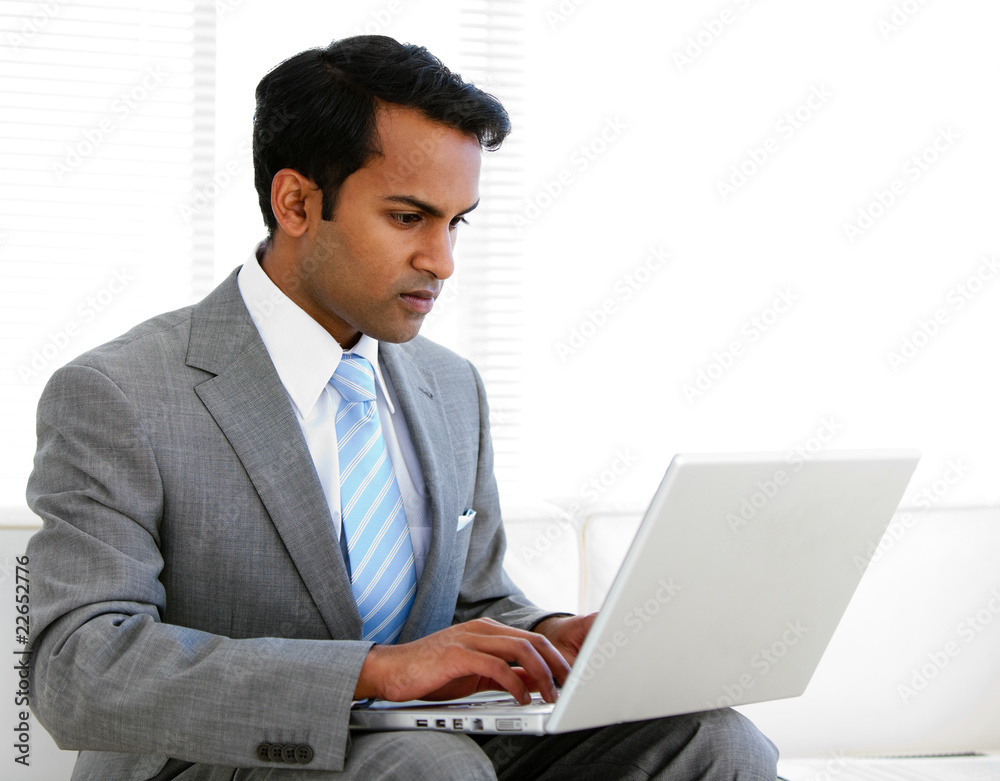 Self-assured businessman working on his computer Self-assured businessman working on his computer