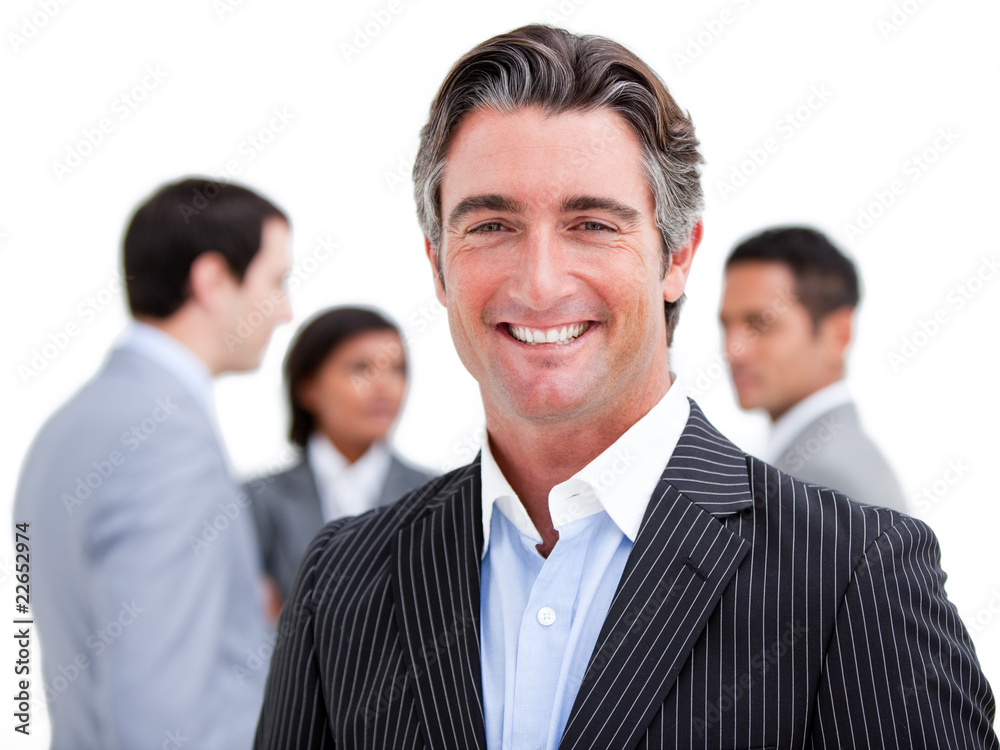 Charismatic mature businessman standing with his team Charismatic mature businessman standing with his team