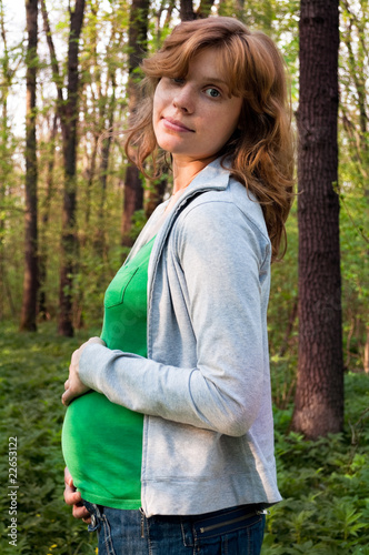 young pregnant woman holding her hands on her tummy