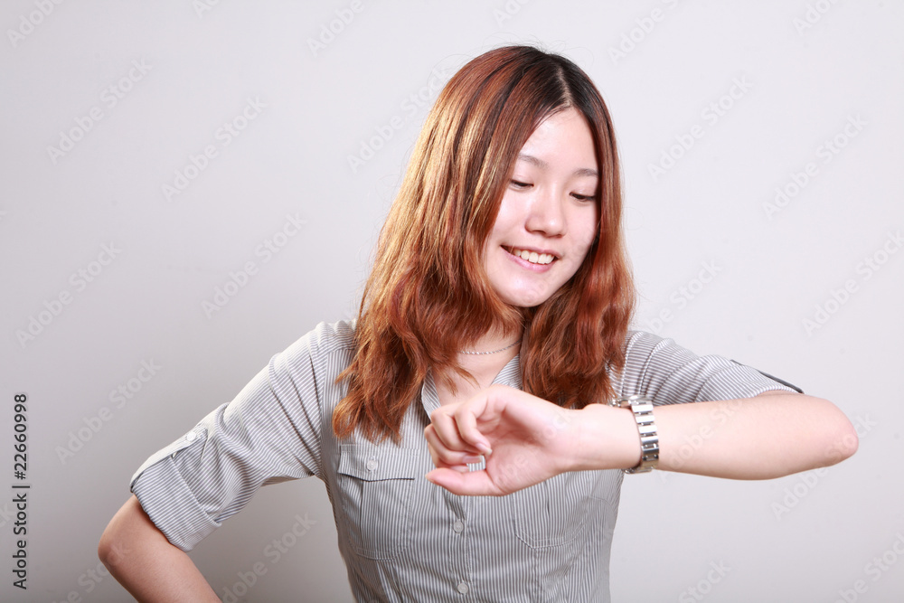 Girl with watch on hand isolated in white background .