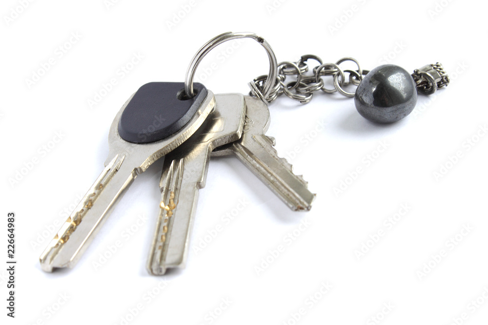 Keys with metal chain and hematite stone isolated on white Keys with metal chain and hematite stone isolated on white