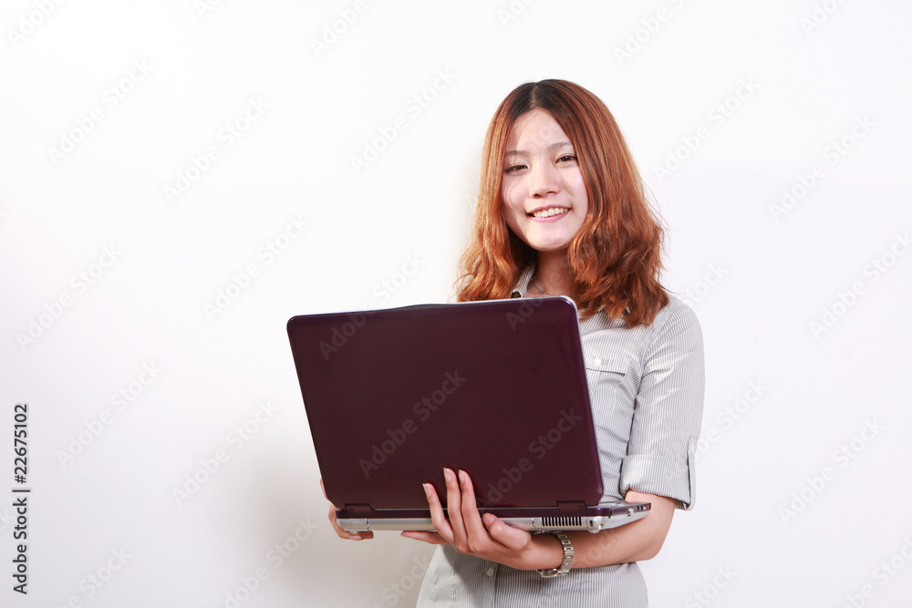 Laughing woman using a laptop against a white background . Laughing woman using a laptop against a white background .