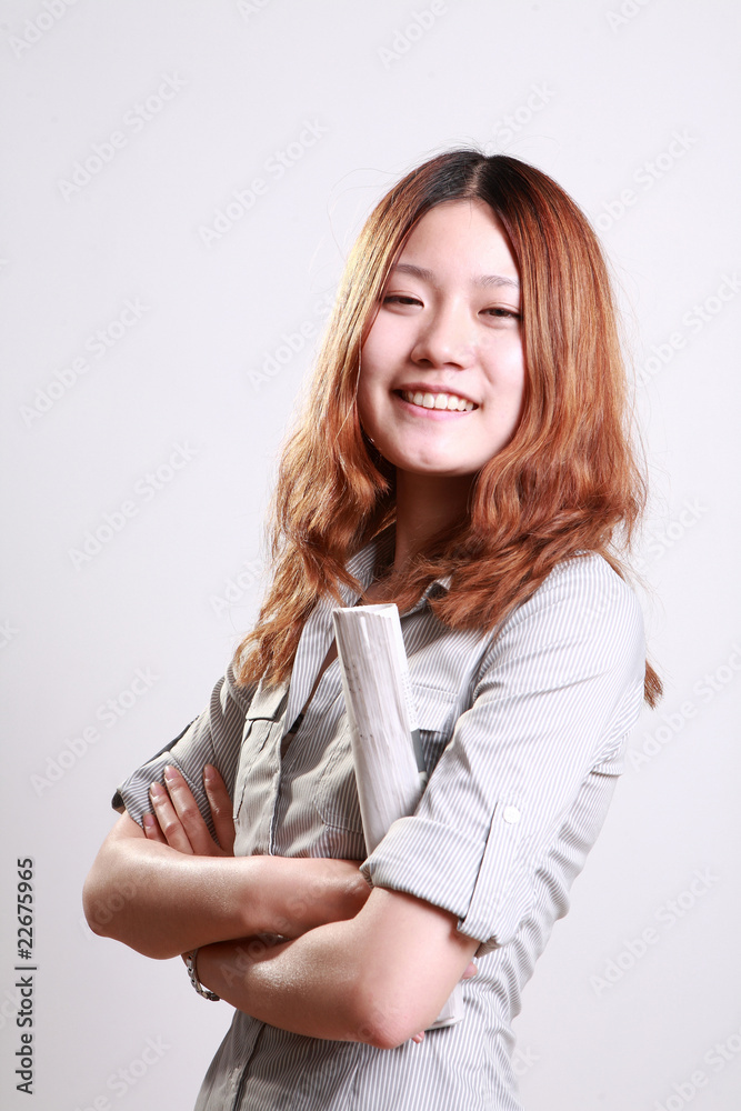A beautiful smiling woman holding a rolled newspaper A beautiful smiling woman holding a rolled newspaper