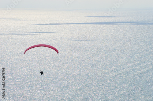paraglider flying over the sea