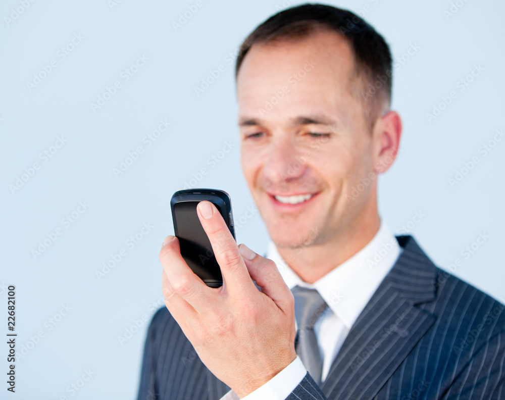 Self-assured businessman sending a text with his phone Self-assured businessman sending a text with his phone