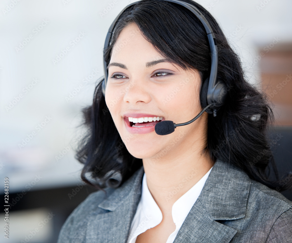 Joyful businesswoman wearing a headset to talk with customer Joyful businesswoman wearing a headset to talk with customer