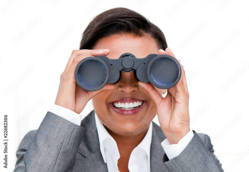 Assertive businesswoman looking through binoculars Assertive businesswoman looking through binoculars