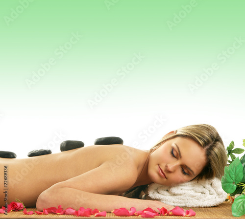 A young and attractive woman is getting spa treatment