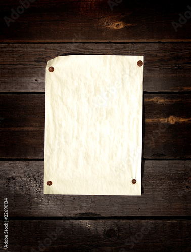 Old paper tacked to a wood wall