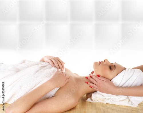 A young and attractive woman is getting spa treatment