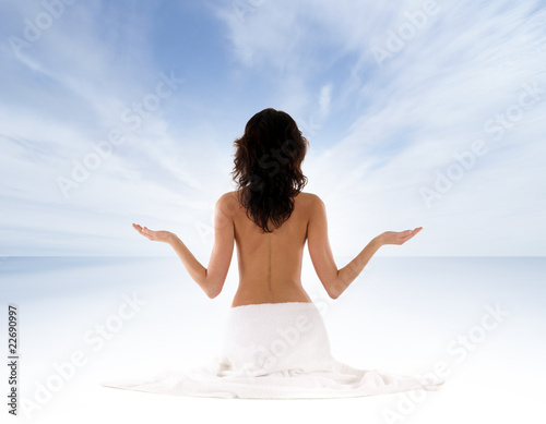 Image of a young and fit brunette meditating
