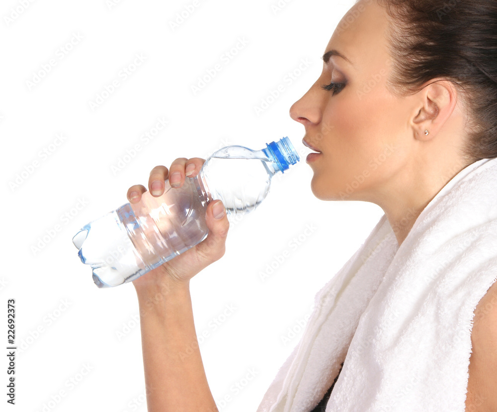 A young and sporty female is drinking fresh water after training A young and sporty female is drinking fresh water after training