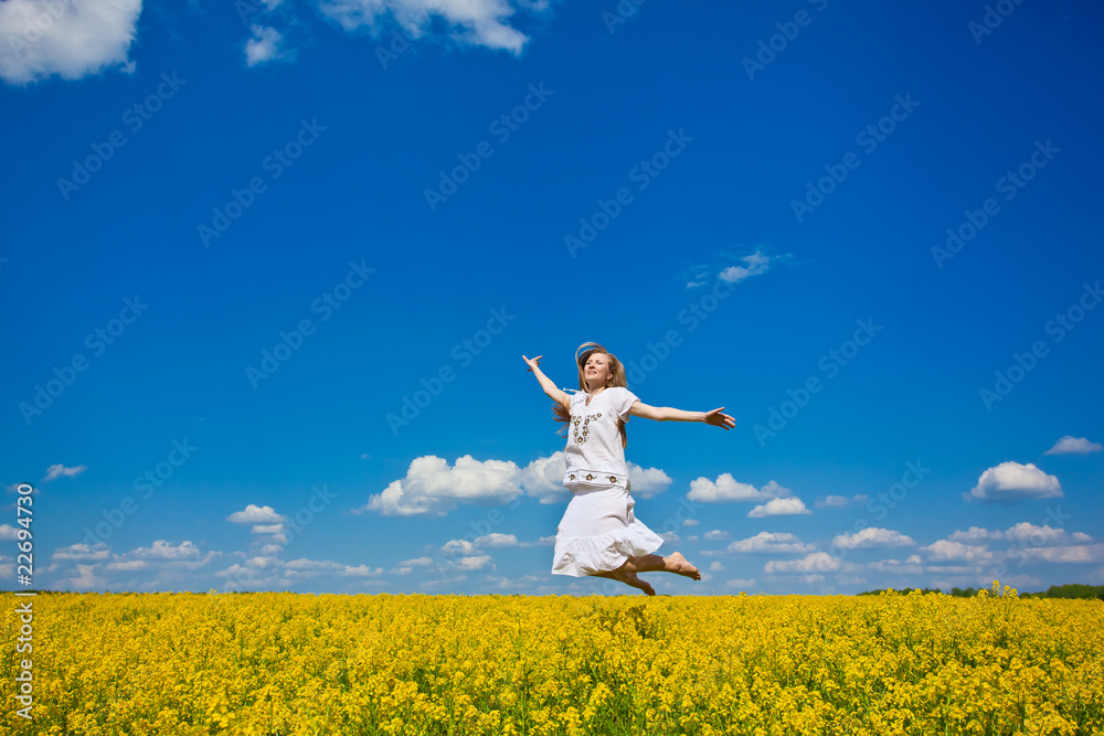 beautiful young woman jumping on field in summer beautiful young woman jumping on field in summer