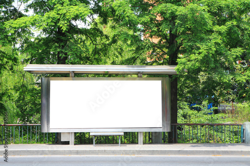 a bus stop with a blank billboard for your advertising .