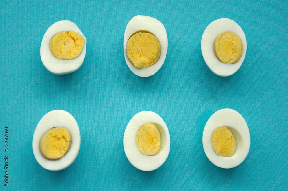 six sliced eggs on blue six sliced eggs on blue