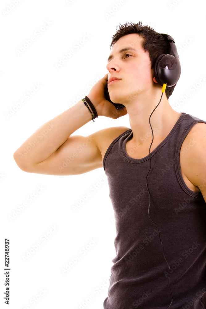 Naklejka premium Young man listening music isolated on white