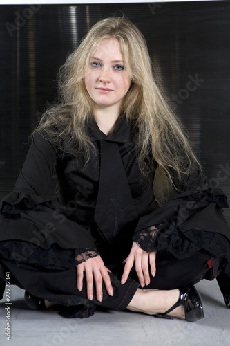 Photography teen girl wearing Gothic clothes sitting on the flower