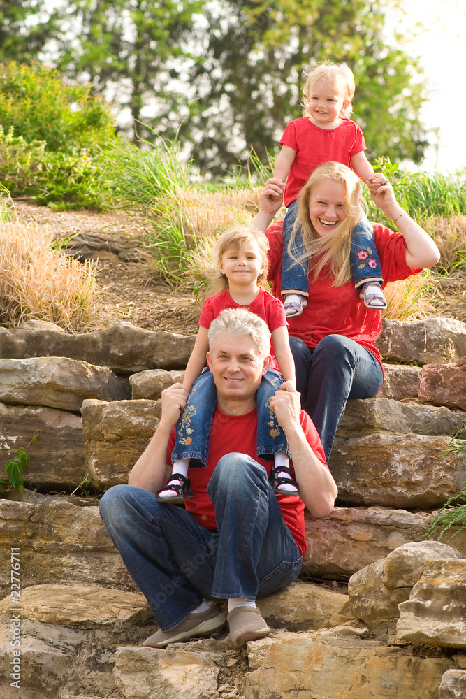 Fototapeta premium Happy family outdoor in red above each other