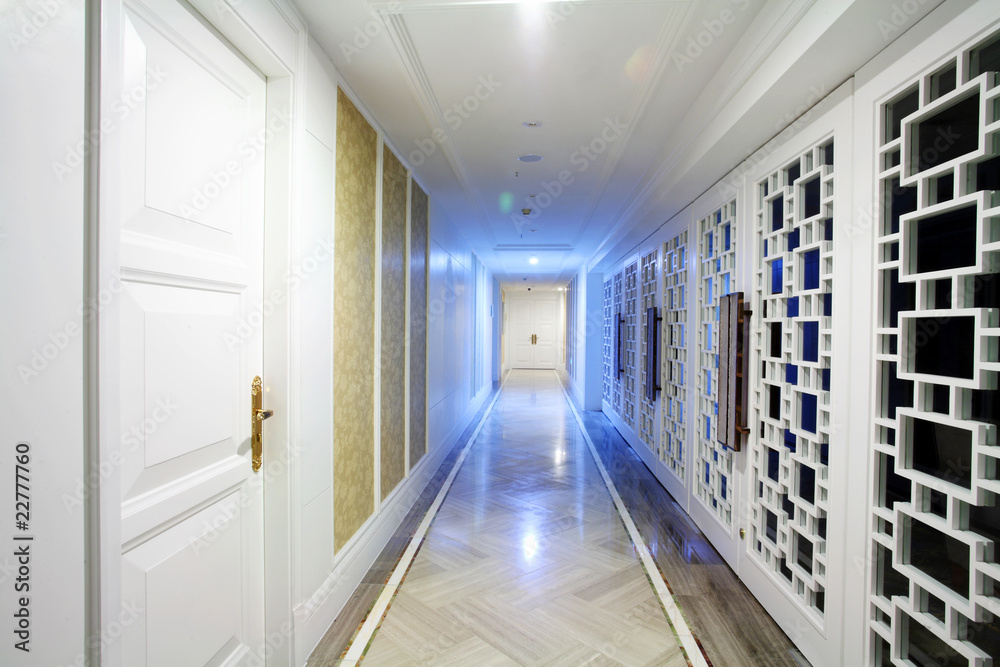 Empty hotel corridor with blue doors