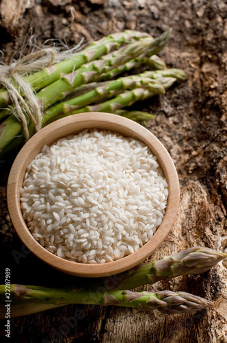 bowl with rice and raw asparagus