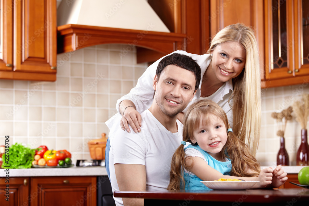Parents with the child on kitchen Parents with the child on kitchen
