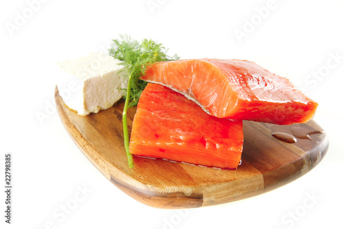 pink salmon on wooden plate with cheese